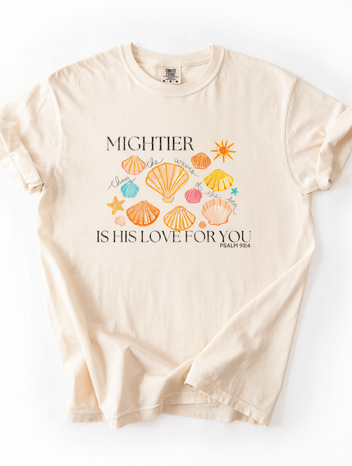 flat lay of Mightier Is His Love Tee