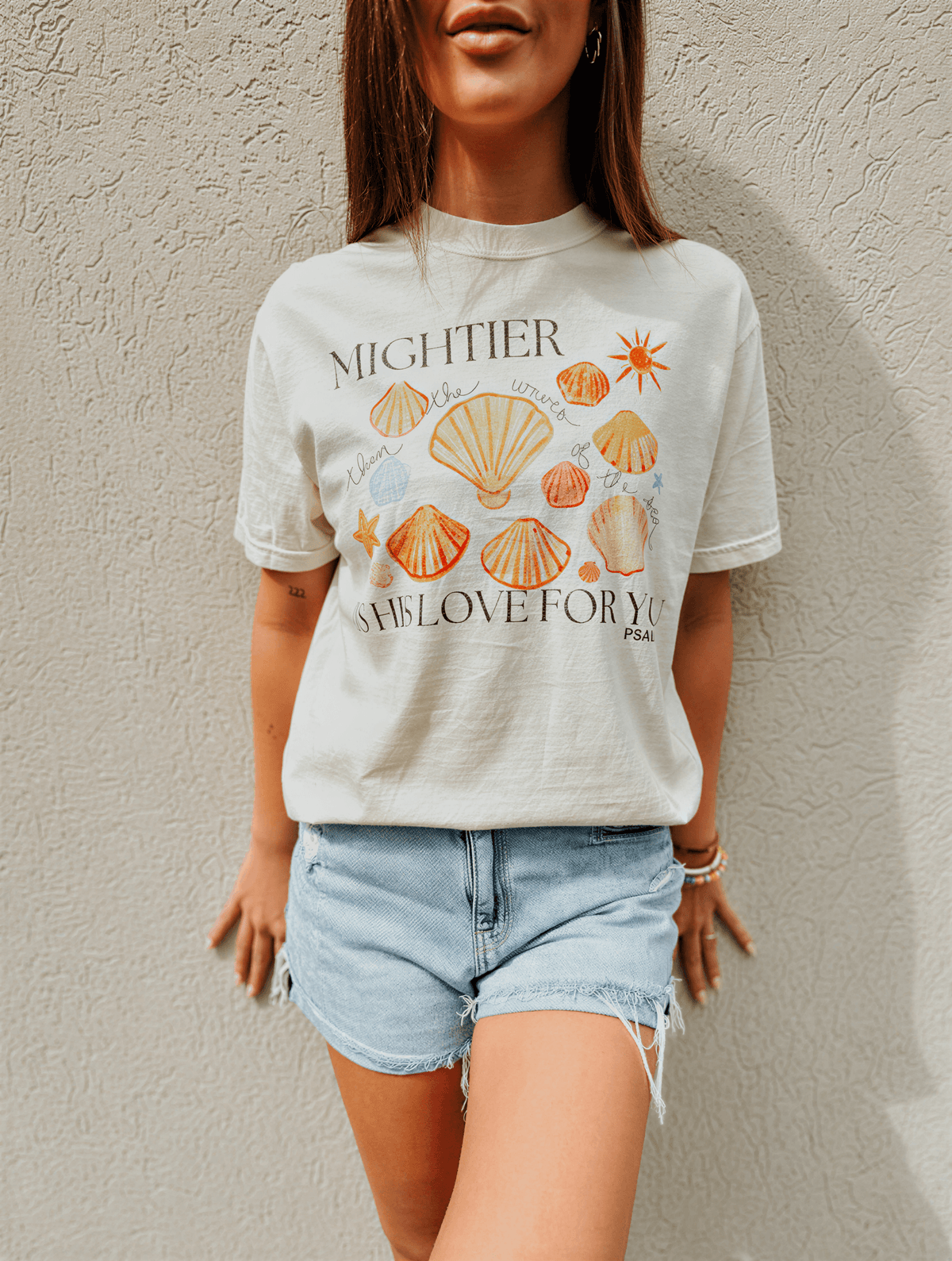 model wearing Mightier Is His Love Tee