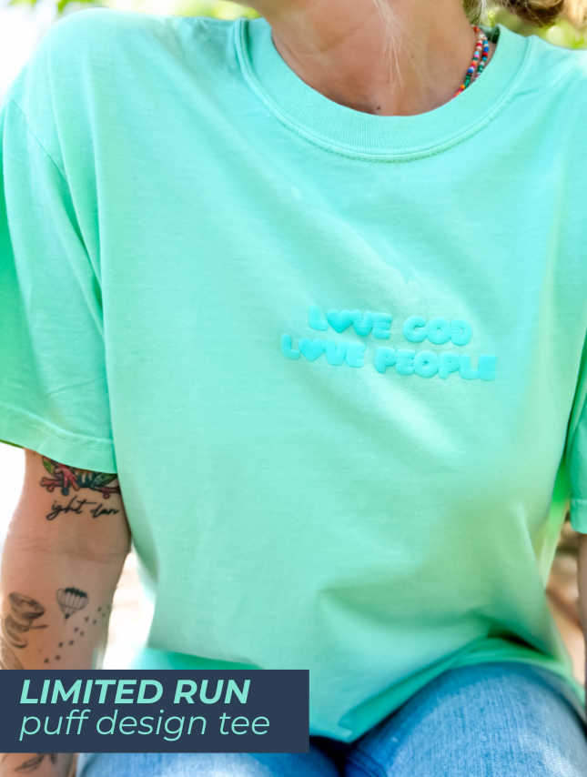 Light green puff tee featuring the text "Love God Love People" in a raised design.